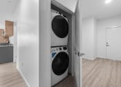 Thumbnail 10 of 20 - a washer and dryer in a laundry room with a door