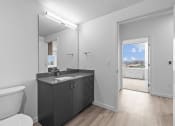 Thumbnail 8 of 20 - a bathroom with a mirror and a toilet and a sink