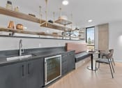 Thumbnail 13 of 20 - a kitchen with a sink and a bar and a living room with a couch