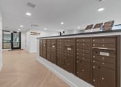 Thumbnail 19 of 20 - a lockers in a room with a wooden floor and white walls