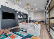 Thumbnail 14 of 20 - a living room with a couch and a tv