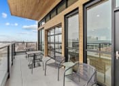 Thumbnail 20 of 20 - a balcony with tables and chairs and glass doors