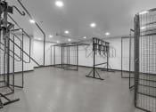 Thumbnail 17 of 20 - a large white room with many cages and a white wall in the background