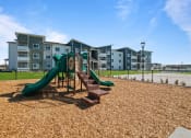 Thumbnail 10 of 21 - the preserve at ballantyne commons playground with slides and buildings