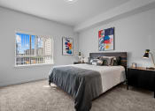 Thumbnail 18 of 21 - a bedroom with a bed and a large window