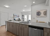 Thumbnail 15 of 21 - an open kitchen with a large counter top and a sink