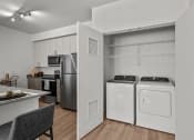 Thumbnail 21 of 21 - a kitchen with white appliances and a laundry room with stainless steel appliances