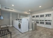 Thumbnail 10 of 13 - A laundry room with a washer and dryer in it.