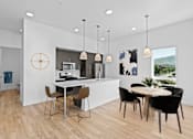Thumbnail 2 of 22 - A modern kitchen with a dining table and chairs.