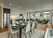 Thumbnail 2 of 20 - a kitchen and living room with a table and chairs