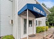 Thumbnail 20 of 23 - A building with a blue awning that says Heron Hills.