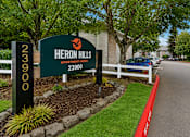 Thumbnail 17 of 23 - A sign for Heron Hills Apartment Homes with the number 23900 on it.