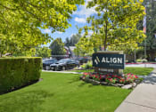 Thumbnail 5 of 18 - a sign on a lawn with cars in the background