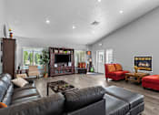 Thumbnail 6 of 12 - the living room has a fireplace and leather couches