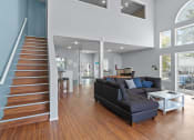 Thumbnail 22 of 34 - a living room with a staircase and a couch      and a