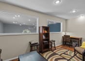 Thumbnail 20 of 34 - a living room with a desk and a window