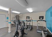 Thumbnail 23 of 34 - a gym with treadmills and other exercise equipment at the enclave at university heights