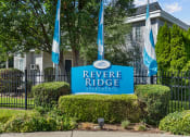 Thumbnail 1 of 34 - a blue reverse ridge apartments sign in front of a black fence