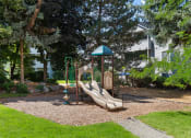 Thumbnail 5 of 34 - a playground with slides and a fire hydrant in a yard