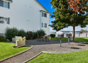 Thumbnail 20 of 32 - Farr Court Exterior Building Green Grass and Grilling Area