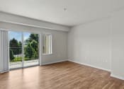 Thumbnail 6 of 45 - a bedroom with a sliding glass door and hardwood floors