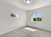 Thumbnail 12 of 45 - a bedroom with two windows and a carpeted floor