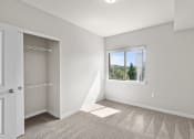 Thumbnail 15 of 45 - an empty bedroom with a large window and a closet