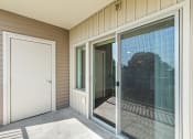 Thumbnail 14 of 45 - a large sliding glass door leading to a balcony