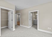 Thumbnail 12 of 48 - a bedroom with two closets and a bathroom in the background