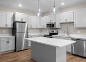 Thumbnail 10 of 48 - a kitchen with white cabinets and stainless steel appliances