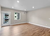 Thumbnail 20 of 48 - a bedroom with a hardwood floor and grey walls
