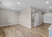 Thumbnail 35 of 48 - a bedroom with a medium sized bed and a closet with a sliding door
