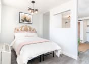 Thumbnail 4 of 12 - a bedroom with a bed and a mirror