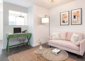 Thumbnail 7 of 12 - a living room with a green desk and a pink couch