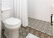 Thumbnail 8 of 12 - a bathroom with white subway tile and a white shower curtain
