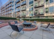 Thumbnail 10 of 22 - Exterior and Patio with Fire Pit at Koi Apartments, Seattle, 98107