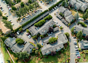 Thumbnail 20 of 20 - A bird's eye view of a residential area with houses and cars.