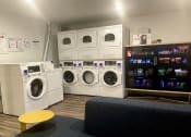 Thumbnail 7 of 33 - a laundry room with washers and dryers