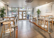 Thumbnail 18 of 29 - A view of a cafeteria with tables and chairs.
