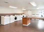 Thumbnail 5 of 24 - Maple Ridge Apartments Laundry Facility