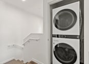 Thumbnail 31 of 34 - A washing machine is placed in a small room.