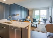 Thumbnail 2 of 35 - A modern kitchen with dark grey cabinets and stainless steel appliances.