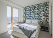 Thumbnail 9 of 35 - A bedroom with a large bed and a floral wallpaper.