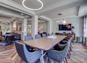 Thumbnail 21 of 39 - Lux Apartments Bellevue WA conference room with large meeting table and TV for small gatherings like business presentations or game night