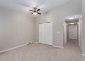 Thumbnail 31 of 39 - Novela Apartments Bedroom with Ceiling Fan and Closet Door