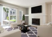 Thumbnail 1 of 39 - a living room with a fireplace and a tv above it