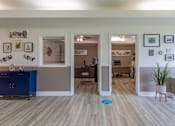 Thumbnail 9 of 14 - A room with a blue cabinet and a white fridge.