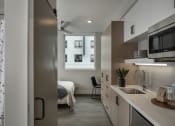 Thumbnail 18 of 33 - a bedroom with a large window in a 555 waverly unit