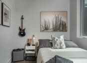 Thumbnail 22 of 33 - a small bedroom with a bed and a guitar on the wall