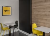 Thumbnail 11 of 33 - a room with two tables and two chairs with a yellow sign on the wall that says quiz